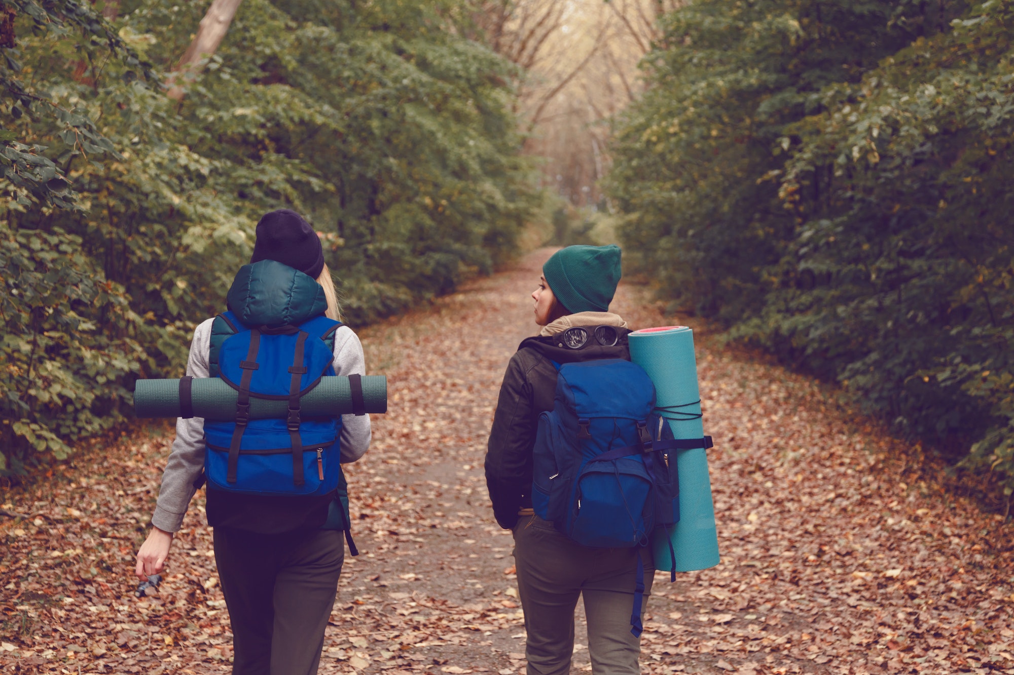 2 women hiking and camping with rucksacks